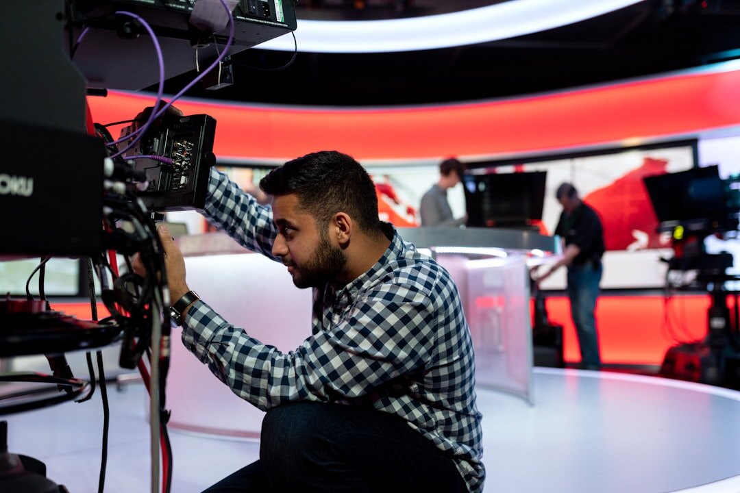 Studio technician working on broadcast camera maintenance